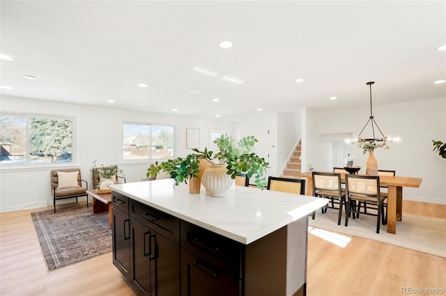 kitchen with recessed lighting, light wood-style flooring, a center island, and light countertops