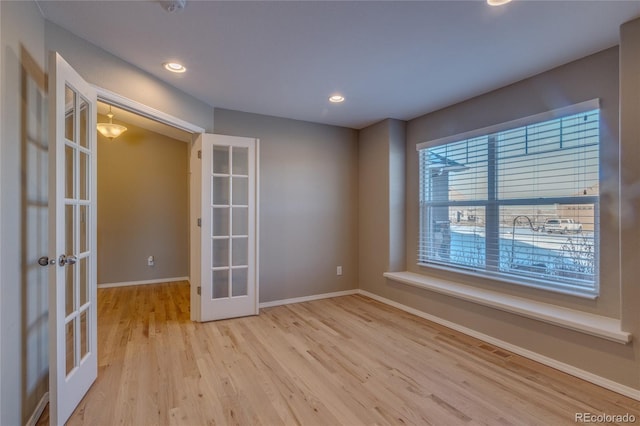 unfurnished room featuring light wood-type flooring and french doors