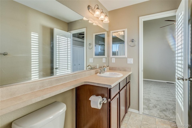 bathroom with vanity, toilet, and ceiling fan