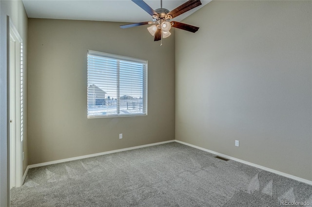 carpeted empty room with ceiling fan and lofted ceiling