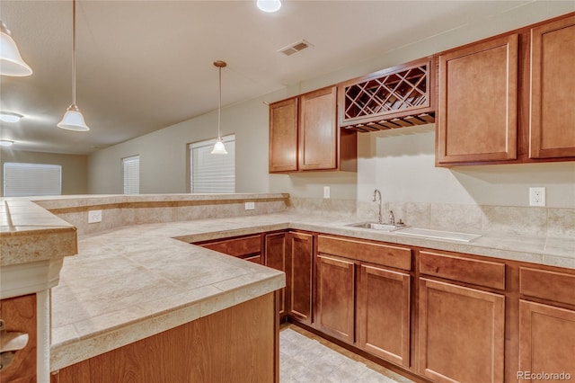 kitchen featuring sink, hanging light fixtures, and kitchen peninsula