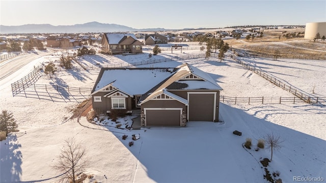 snowy aerial view featuring a mountain view