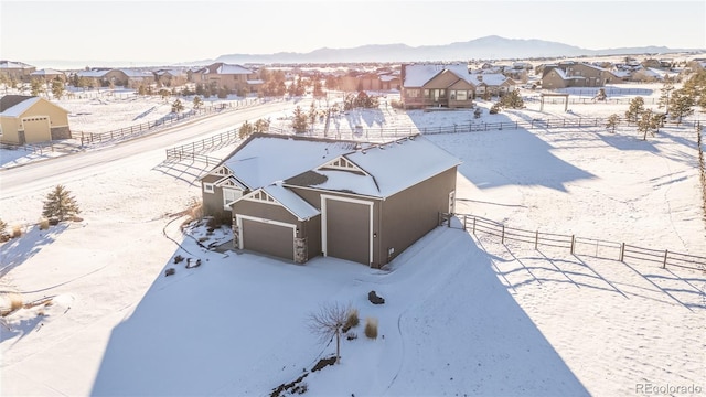 snowy aerial view featuring a mountain view