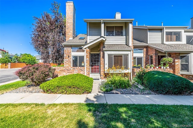 4207 S Granby Ct Unit A, Aurora, CO 80014 - view of front of property with a chimney, brick siding, and roof with shingles