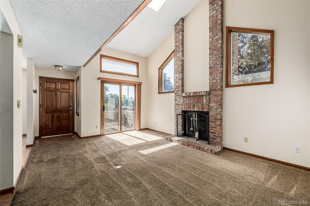4207 S Granby Ct Unit A, Aurora, CO 80014 - unfurnished living room with plenty of natural light, a fireplace, high vaulted ceiling, carpet, and a textured ceiling