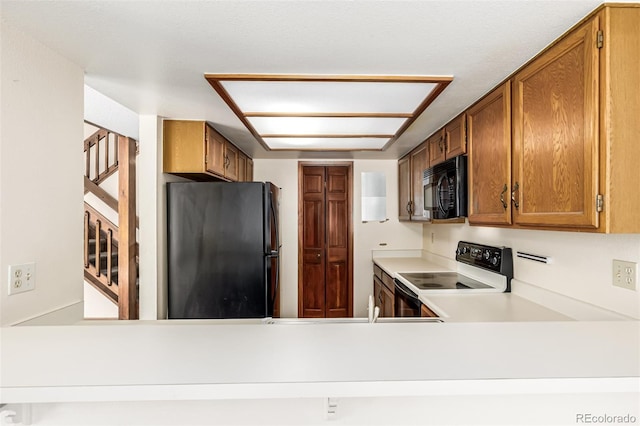 4207 S Granby Ct Unit A, Aurora, CO 80014 - kitchen featuring black appliances, brown cabinets, and light countertops