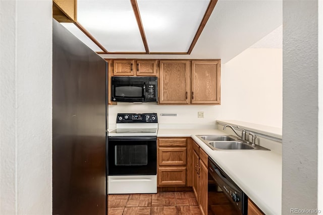 4207 S Granby Ct Unit A, Aurora, CO 80014 - kitchen featuring black appliances, light countertops, and brown cabinetry