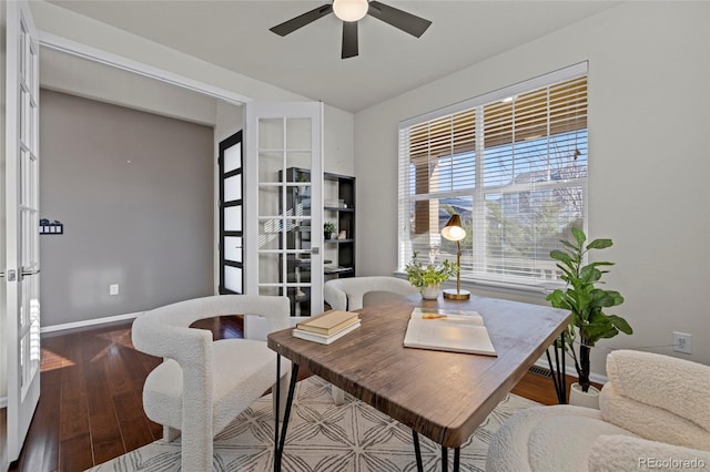 dining room featuring wood-type flooring, french doors, and ceiling fan