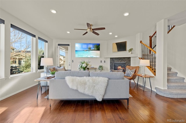 living room with dark hardwood / wood-style flooring and ceiling fan