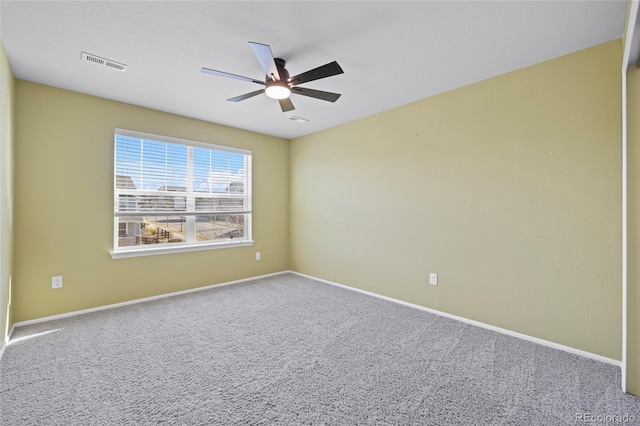 carpeted spare room with ceiling fan