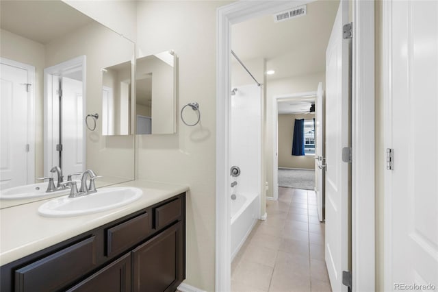 bathroom with washtub / shower combination, vanity, tile patterned floors, and ceiling fan