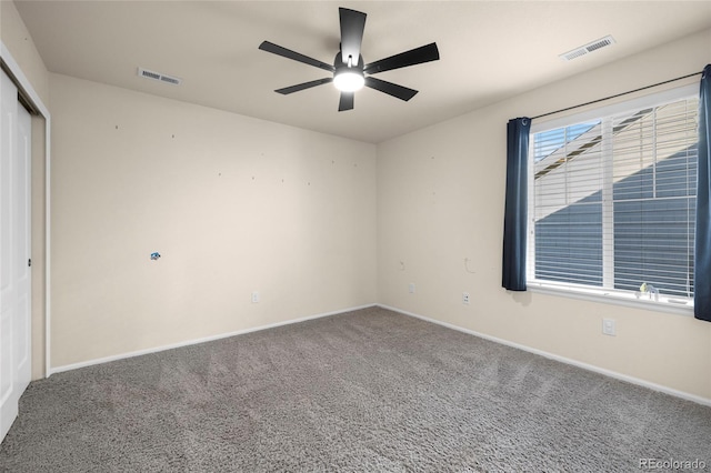 carpeted spare room featuring ceiling fan