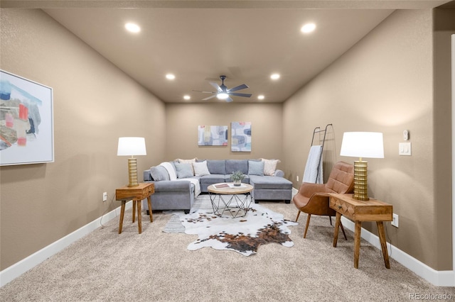 carpeted living room with ceiling fan