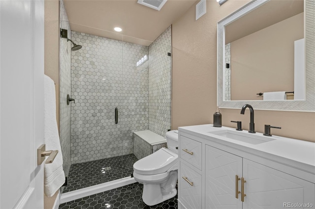 bathroom with tile patterned flooring, vanity, toilet, and a shower with shower door