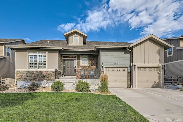 view of front of home with stone siding, board and batten siding, a front yard, and driveway