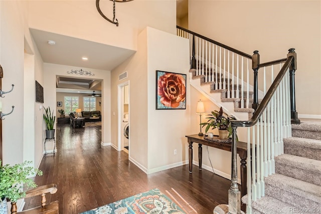 foyer entrance featuring ceiling fan, wood finished floors, visible vents, baseboards, and stairs