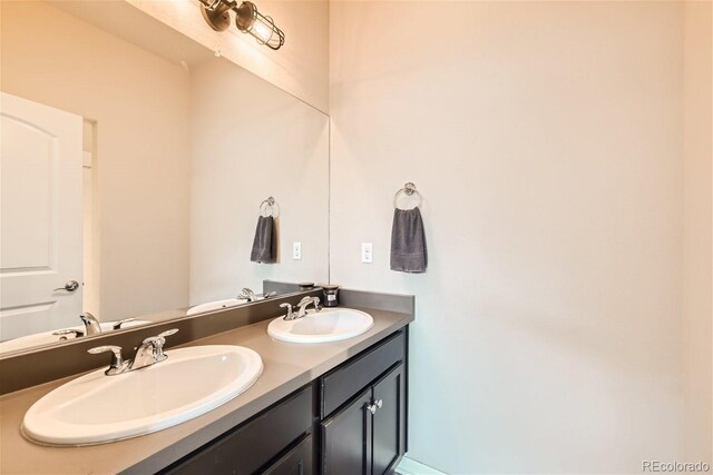 bathroom featuring double vanity and a sink