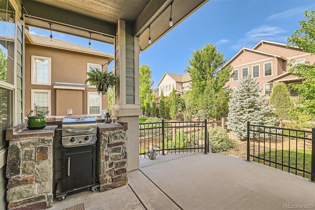 view of patio with fence and a residential view