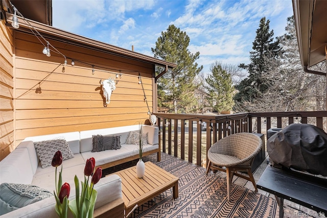 deck featuring an outdoor living space and a grill