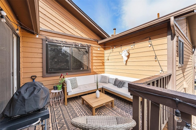 wooden terrace featuring grilling area and an outdoor hangout area