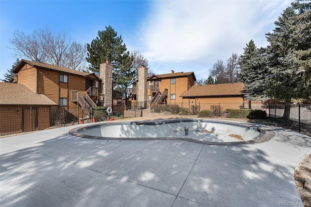 view of swimming pool featuring stairway, a patio, a fenced in pool, and fence