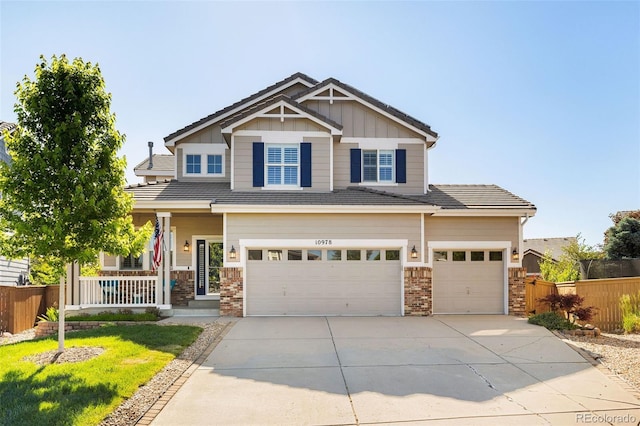 10978 Ashurst Ln, Highlands Ranch, CO 80130 - craftsman inspired home with a porch, concrete driveway, an attached garage, and board and batten siding