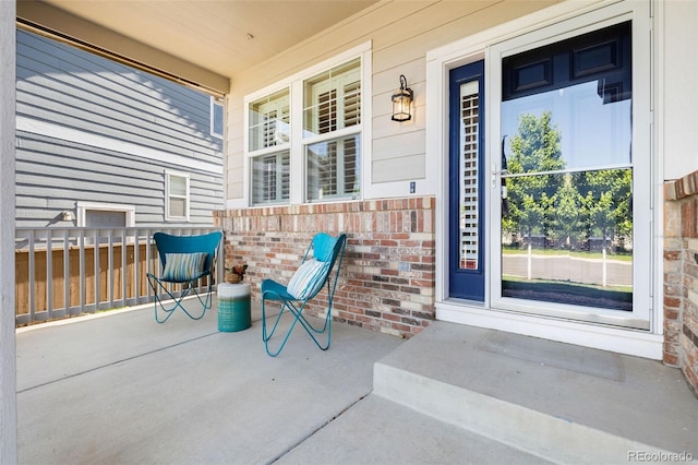 10978 Ashurst Ln, Highlands Ranch, CO 80130 - property entrance featuring covered porch and brick siding