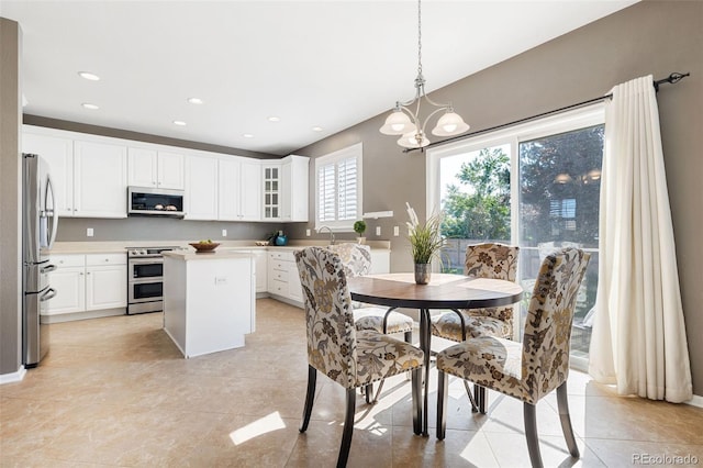 10978 Ashurst Ln, Highlands Ranch, CO 80130 - dining space featuring a chandelier, light tile patterned floors, and recessed lighting