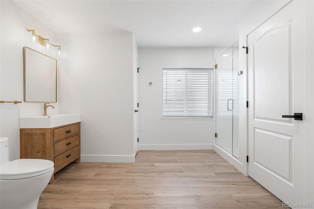 10978 Ashurst Ln, Highlands Ranch, CO 80130 - bathroom featuring vanity, a shower stall, wood finished floors, and recessed lighting