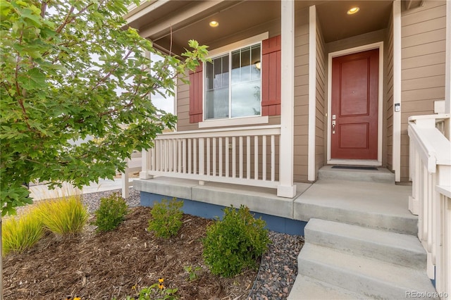 view of exterior entry with covered porch