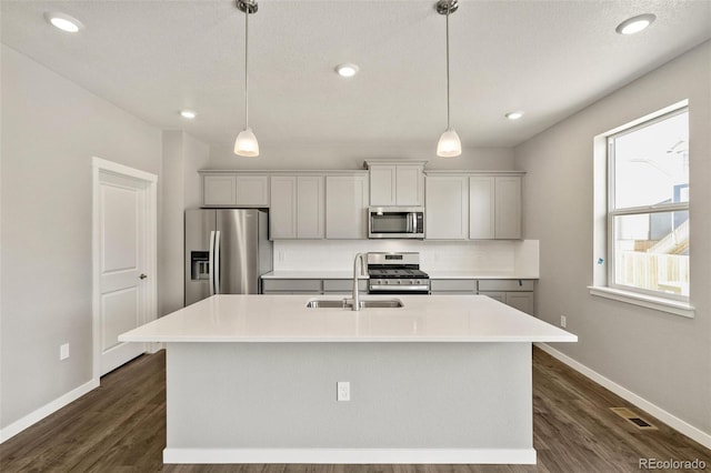 14249 Beebalm Ave, Parker, CO 80134 - kitchen with appliances with stainless steel finishes, a sink, baseboards, dark wood-type flooring, and recessed lighting