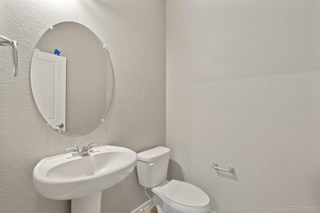 14249 Beebalm Ave, Parker, CO 80134 - bathroom with toilet, a sink, and baseboards