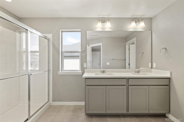 14249 Beebalm Ave, Parker, CO 80134 - bathroom with tile patterned floors, a shower stall, double vanity, and baseboards