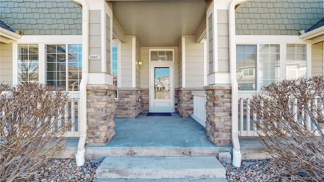 16047 E Geddes Ln Unit 128, Aurora, CO 80016 - view of exterior entry featuring stone siding and covered porch