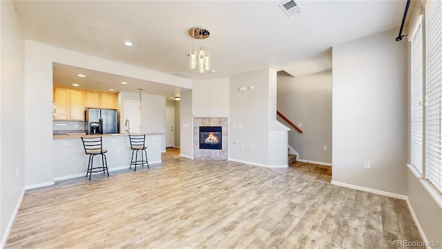 16047 E Geddes Ln Unit 128, Aurora, CO 80016 - unfurnished living room featuring light wood-type flooring, stairway, plenty of natural light, baseboards, and recessed lighting