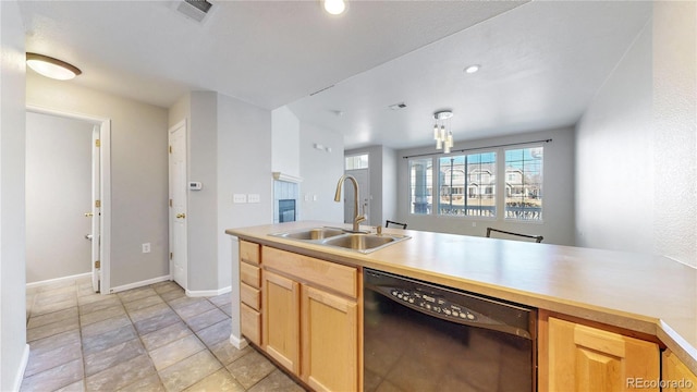 16047 E Geddes Ln Unit 128, Aurora, CO 80016 - kitchen featuring black dishwasher, a sink, light countertops, light brown cabinets, and baseboards