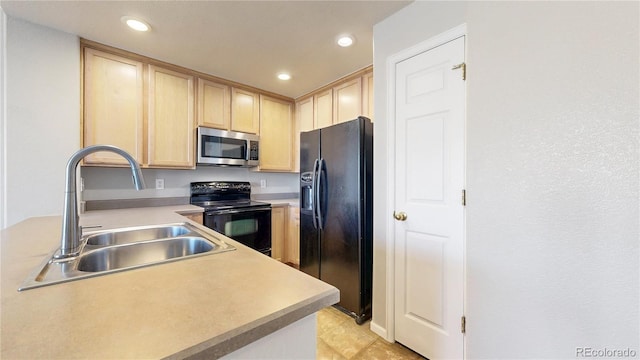 16047 E Geddes Ln Unit 128, Aurora, CO 80016 - kitchen with black appliances, light brown cabinets, a sink, recessed lighting, and light countertops