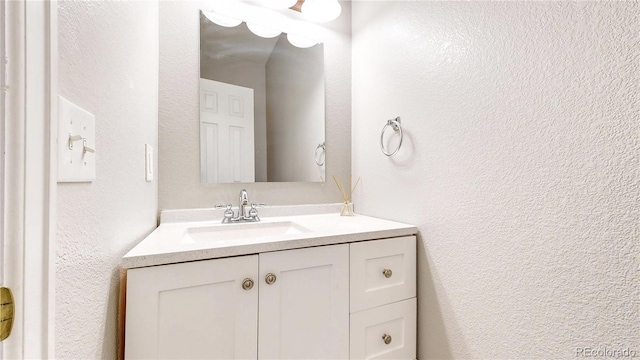 16047 E Geddes Ln Unit 128, Aurora, CO 80016 - bathroom featuring vanity and a textured wall