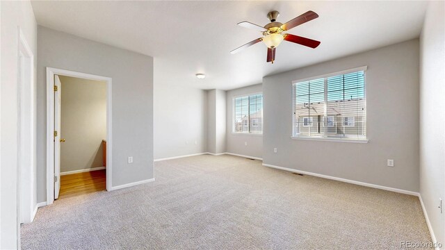 16047 E Geddes Ln Unit 128, Aurora, CO 80016 - empty room with light colored carpet, a ceiling fan, and baseboards