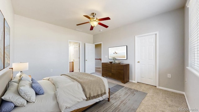 16047 E Geddes Ln Unit 128, Aurora, CO 80016 - bedroom featuring light colored carpet, baseboards, a ceiling fan, and ensuite bath