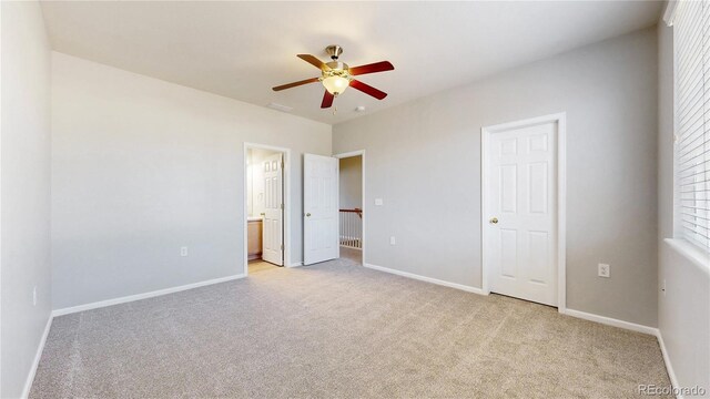 16047 E Geddes Ln Unit 128, Aurora, CO 80016 - unfurnished bedroom with light carpet, baseboards, and ensuite bathroom