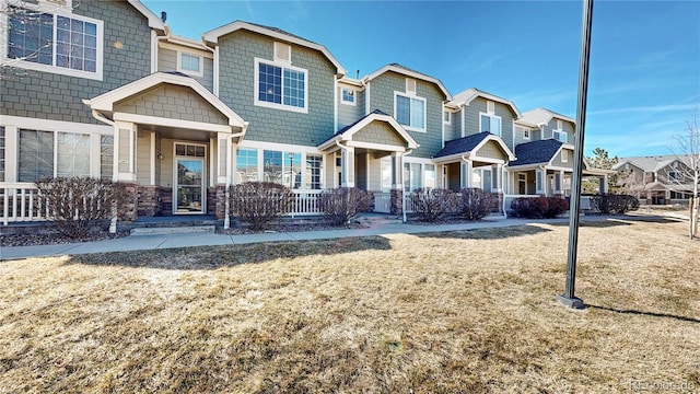 16047 E Geddes Ln Unit 128, Aurora, CO 80016 - view of front of home featuring a residential view, stone siding, and covered porch