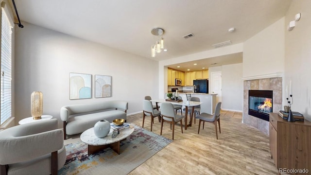 16047 E Geddes Ln Unit 128, Aurora, CO 80016 - living area with light wood-type flooring, baseboards, a tile fireplace, and recessed lighting