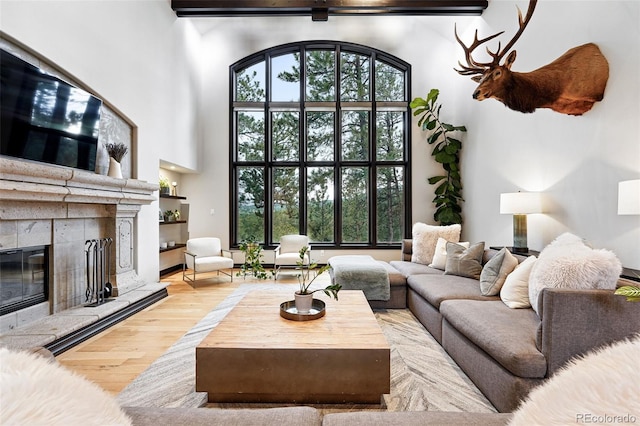 2548 Keystone Dr, Evergreen, CO 80439 - living area with wood finished floors, a high ceiling, and a tile fireplace