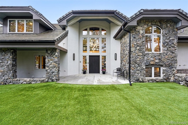 2548 Keystone Dr, Evergreen, CO 80439 - rear view of property with stone siding, stucco siding, and a lawn