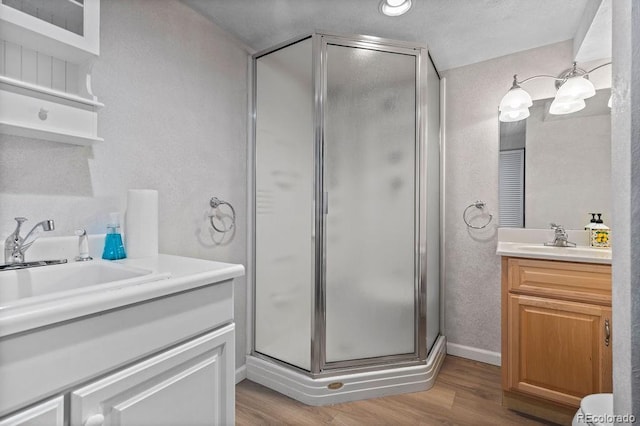7633 S Gilpin Ct, Centennial, CO 80122 - bathroom with a stall shower, vanity, wood finished floors, and baseboards