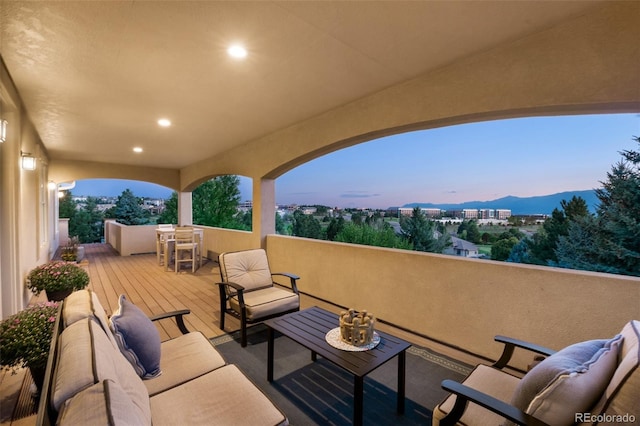 patio terrace at dusk featuring an outdoor hangout area