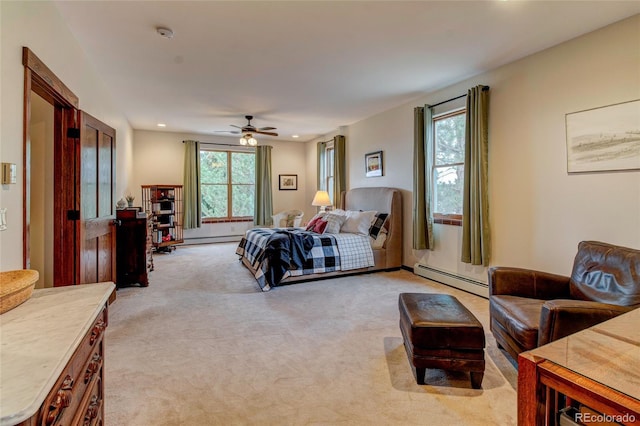 carpeted bedroom with a baseboard heating unit and ceiling fan