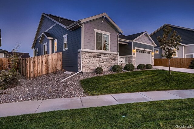 view of front of house featuring a front yard and a garage