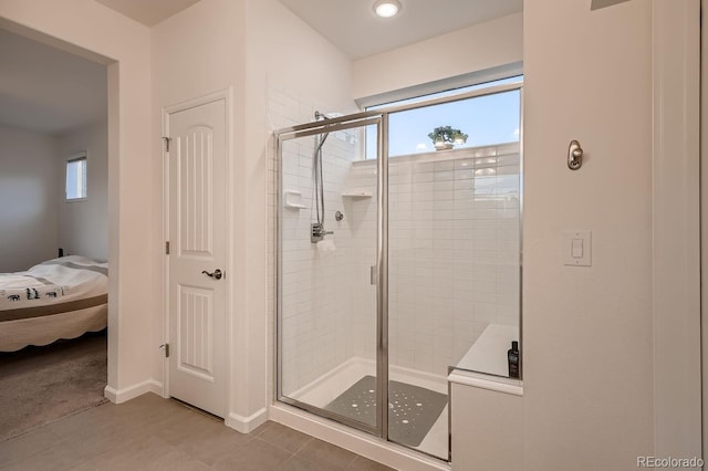 bathroom with tile patterned flooring and walk in shower